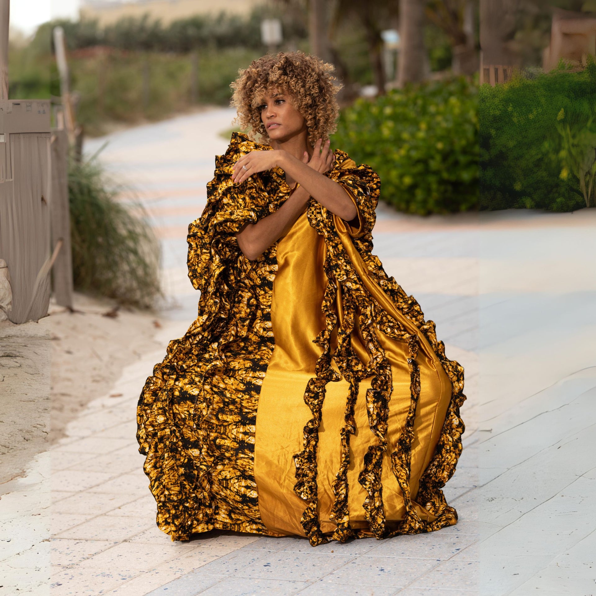 Model wearing Ologo kaftan with Ankara fabric, satin, and ruffled design